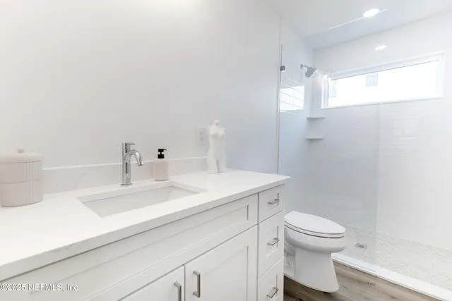 a view of a balcony with wooden floor and fence