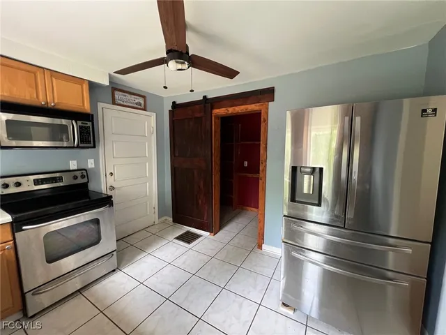 a metallic refrigerator freezer sitting in a kitchen