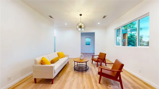 a living room with furniture and a chandelier