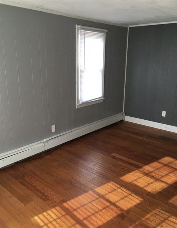 27 Pleasant Street, Unit A Templeton, MA 01468 - Photo 8 of 15 an empty room with wooden floor and windows
