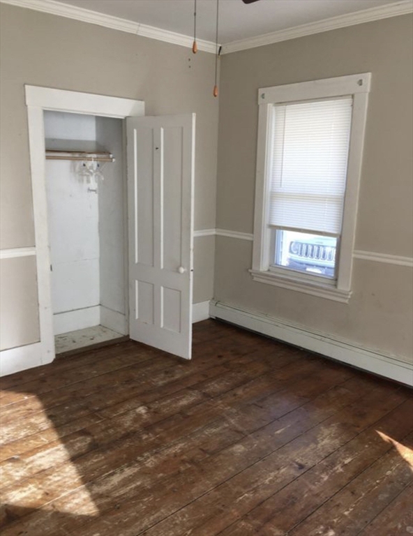 27 Pleasant Street, Unit A Templeton, MA 01468 - Photo 10 of 15 an empty room with wooden floor and windows