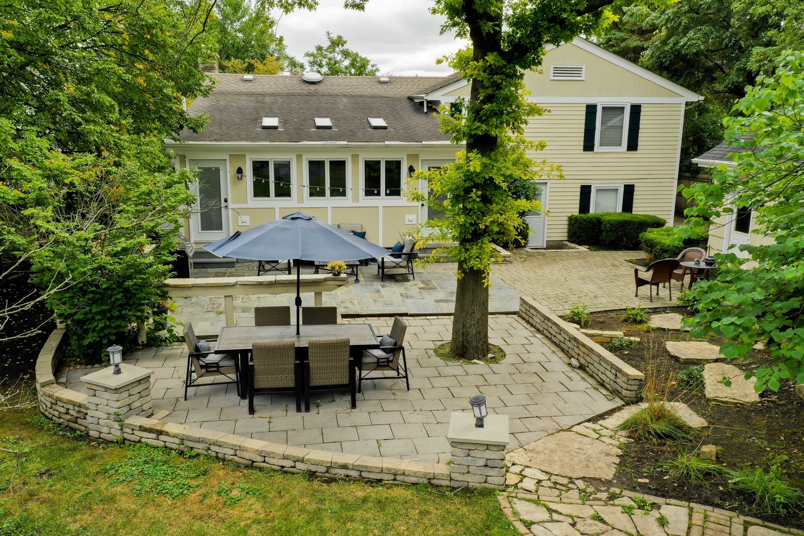 5640 South County Line Road Hinsdale, IL 60521 - Photo 3 of 35 a view of a white house with a yard porch and sitting area