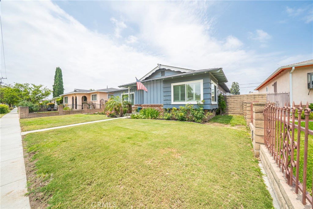 6937 Broadway Whittier, CA 90606 - Photo 2 of 27 a front view of a house with a garden and plants