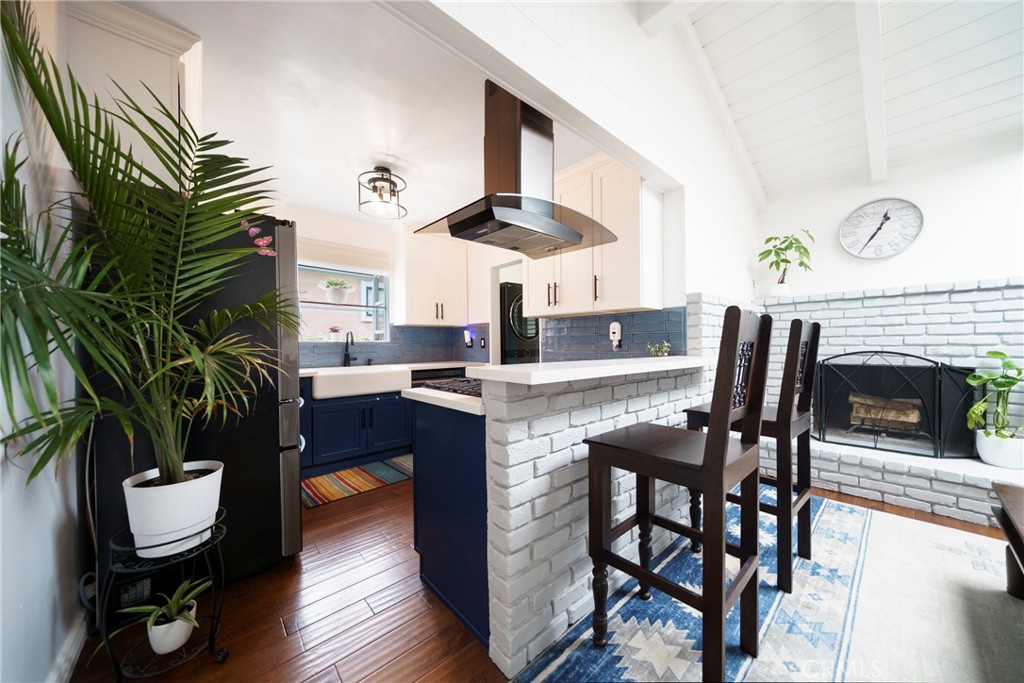 6937 Broadway Whittier, CA 90606 - Photo 8 of 27 a kitchen with a table chairs and a fireplace