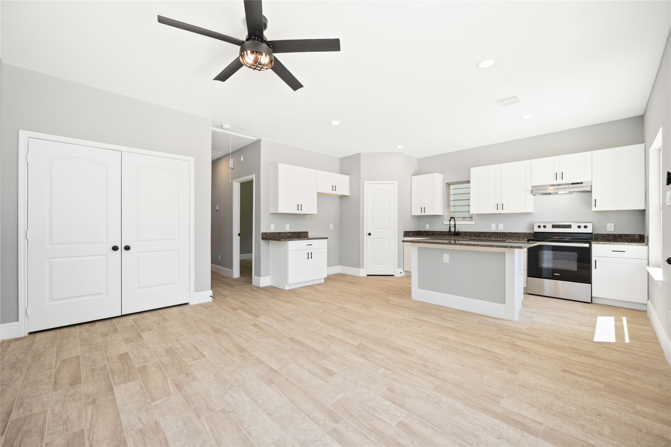 4651 Mallow Street, Unit B Houston, TX 77051 - Photo 13 of 22 a large kitchen with cabinets and stainless steel appliances