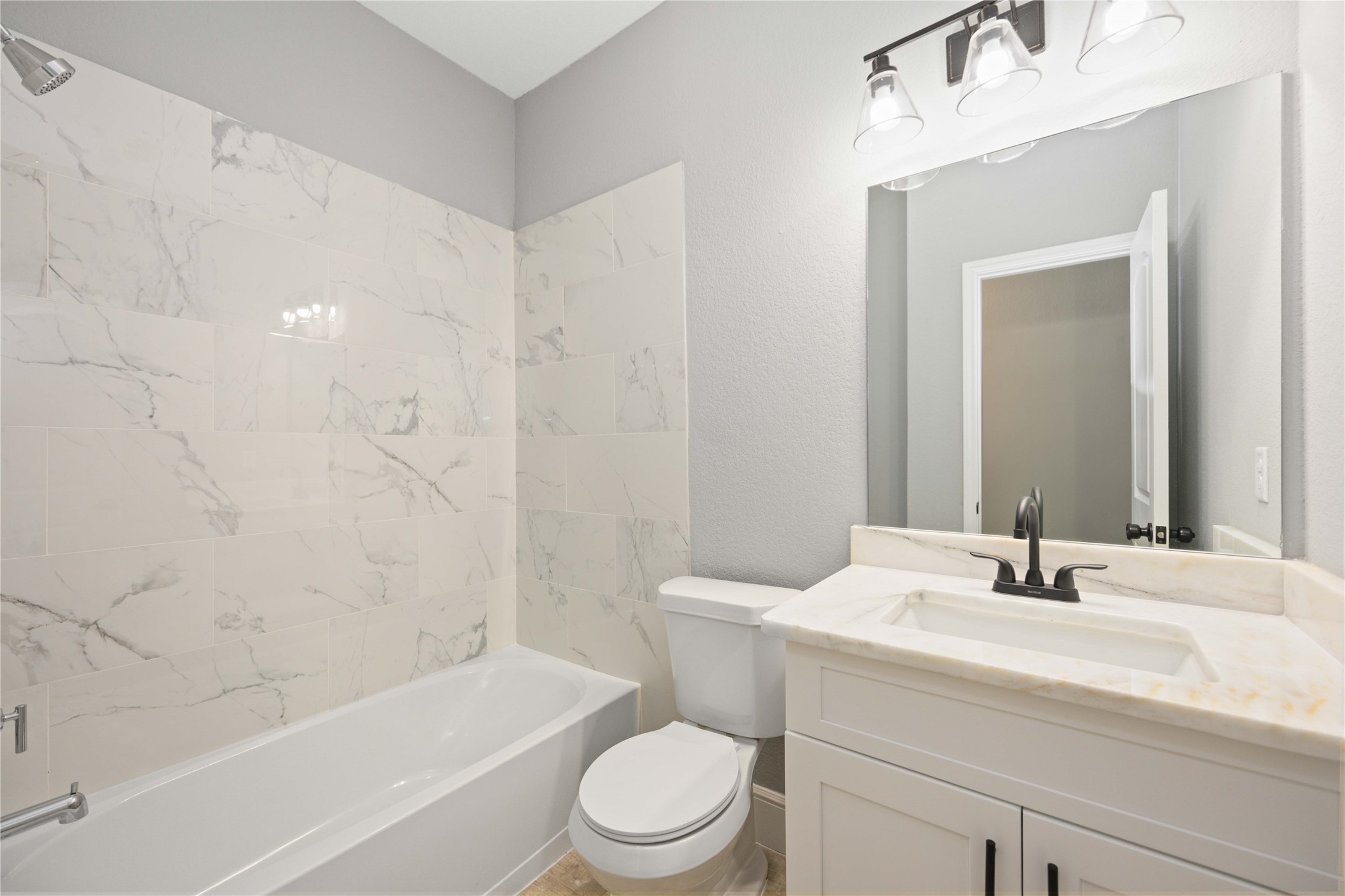 4651 Mallow Street, Unit B Houston, TX 77051 - Photo 18 of 22 a bathroom with a sink a toilet and a bathtub