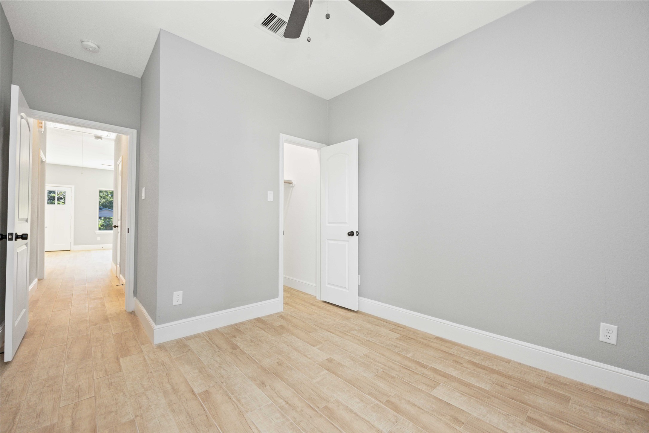 4651 Mallow Street, Unit B Houston, TX 77051 - Photo 20 of 22 a view of a hallway with wooden floor and a chandelier fan