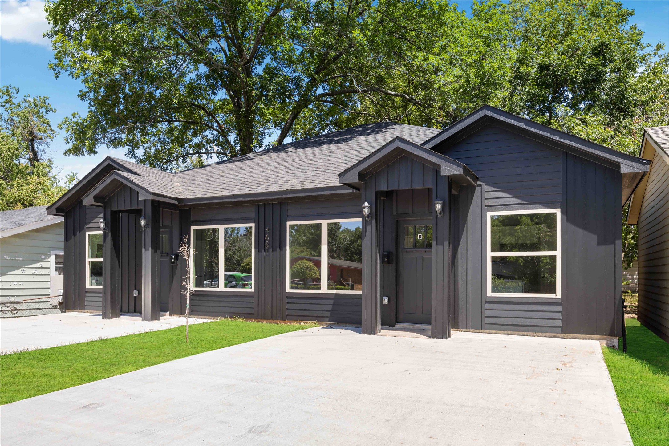 4651 Mallow Street, Unit B Houston, TX 77051 - Photo 2 of 22 a view of a wooden house with a large windows and large trees