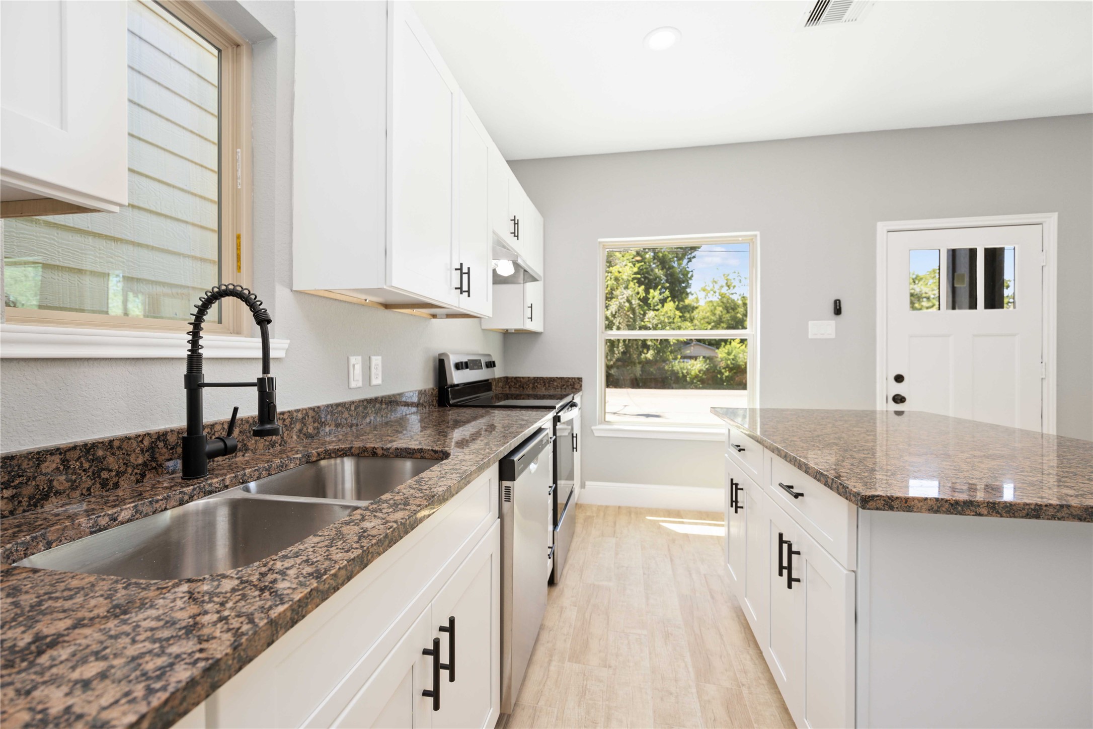 4651 Mallow Street, Unit B Houston, TX 77051 - Photo 7 of 22 a kitchen with granite countertop a sink a counter top space and cabinets