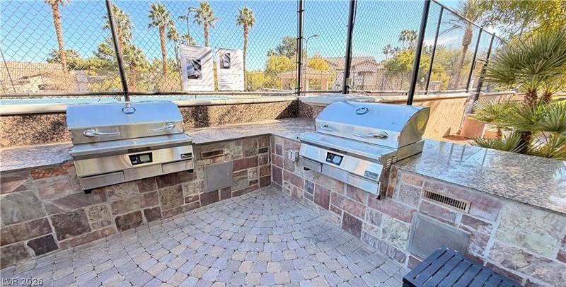 2050 West Warm Springs Road, Unit 2422 Henderson, NV 89014 - Photo 36 of 44 This inviting outdoor space features a well-equipped barbecue area perfect for gatherings.
