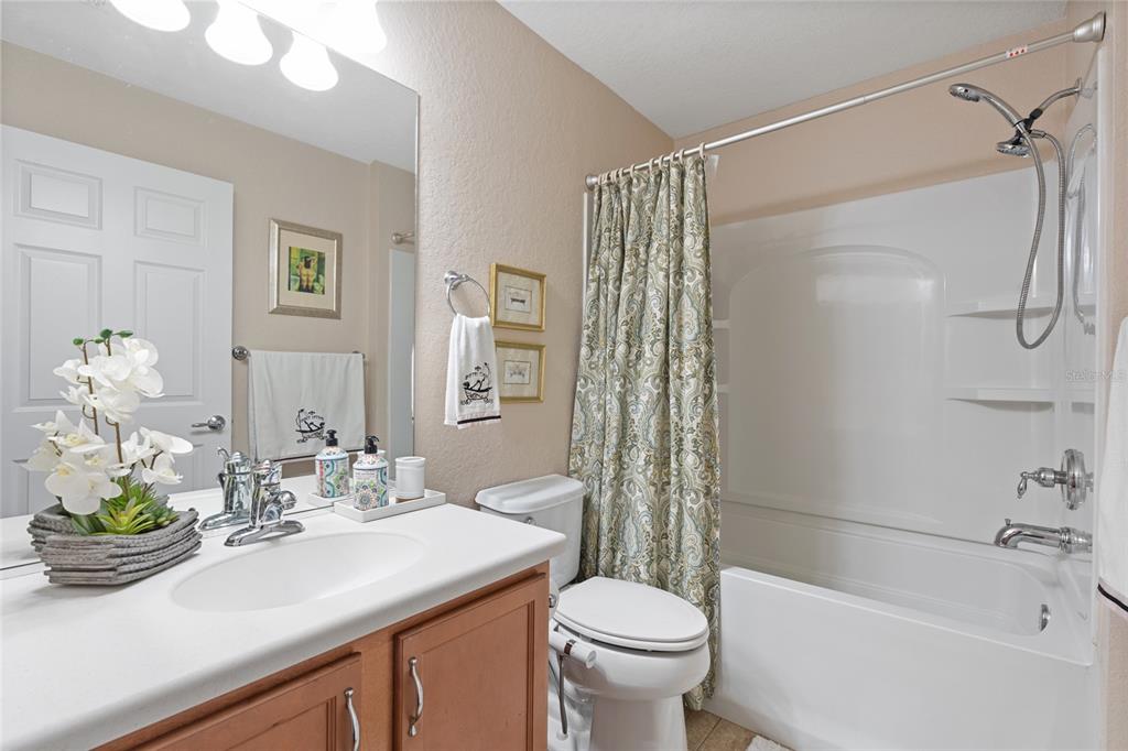4683 Southwest 40th Place Ocala, FL 34474 - Photo 14 of 43 a bathroom with a sink a toilet and shower