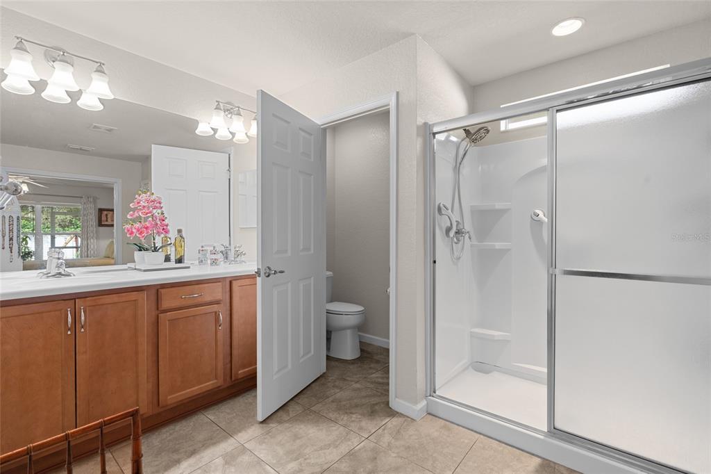 4683 Southwest 40th Place Ocala, FL 34474 - Photo 20 of 43 a bathroom with a granite countertop shower sink mirror and toilet