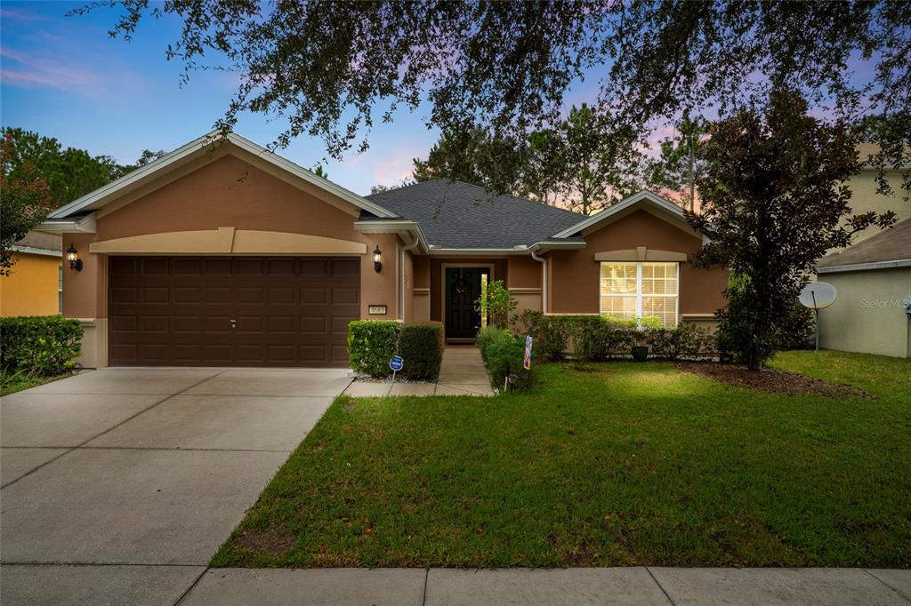 4683 Southwest 40th Place Ocala, FL 34474 - Photo 43 of 43 a front view of a house with yard and green space