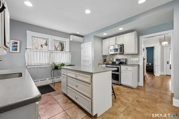 a kitchen with cabinets and chairs in it