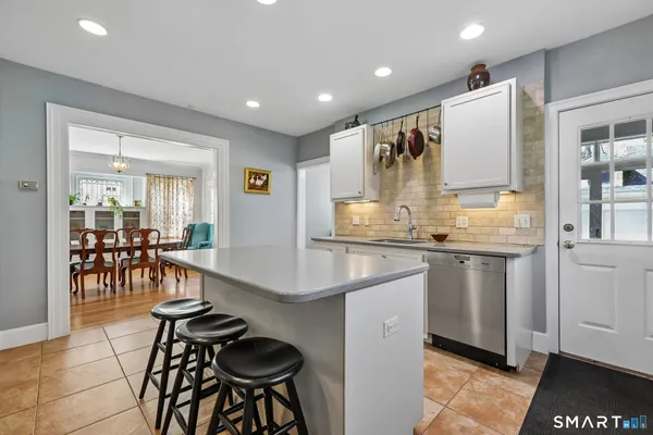 a kitchen with sink cabinets and stainless steel appliances
