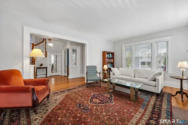 a living room with furniture a fireplace and a window