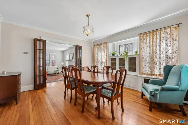 a view of a dining room with furniture window and wooden floor