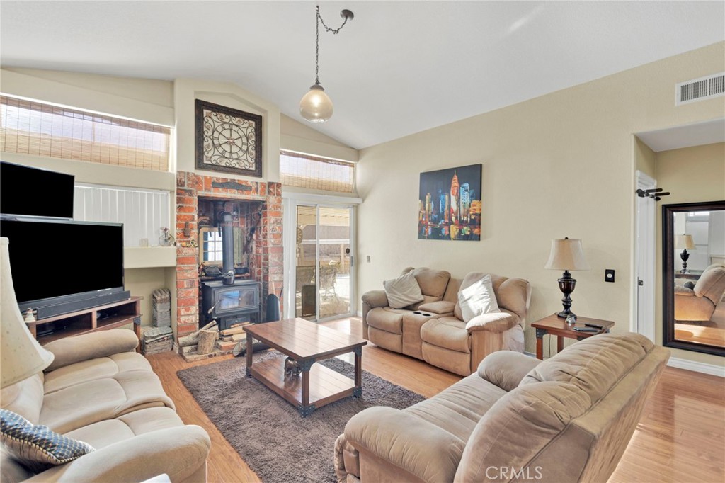 14405 Cedar Street Hesperia, CA 92344 - Photo 14 of 48 a living room with furniture a large window and a flat screen tv