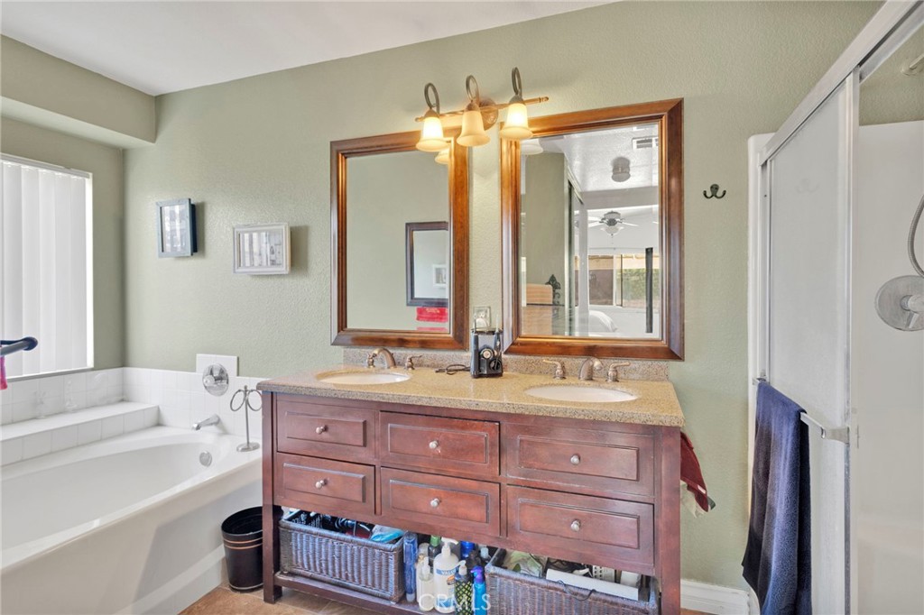 14405 Cedar Street Hesperia, CA 92344 - Photo 20 of 48 a bathroom with a tub a sink and a large mirror