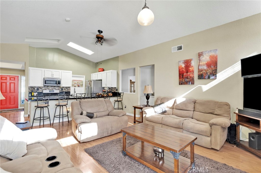 14405 Cedar Street Hesperia, CA 92344 - Photo 23 of 48 a living room with furniture kitchen view and a flat screen tv