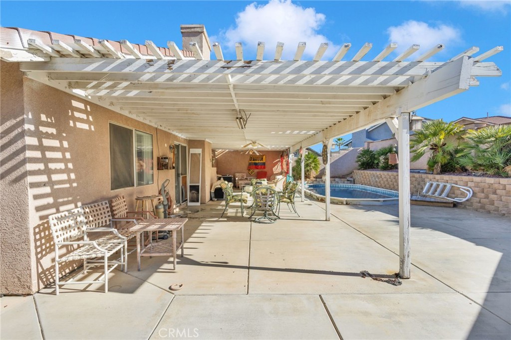 14405 Cedar Street Hesperia, CA 92344 - Photo 34 of 48 a view of a patio with table and chairs potted plants with wooden floor