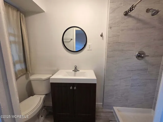 a bathroom with a toilet a sink and a mirror