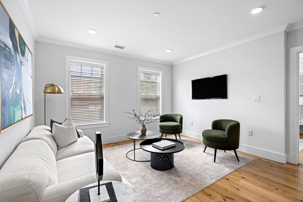 30 Polk Street, Unit 208 Boston, MA 02129 - Photo 7 of 24 a living room with furniture a flat screen tv and a window