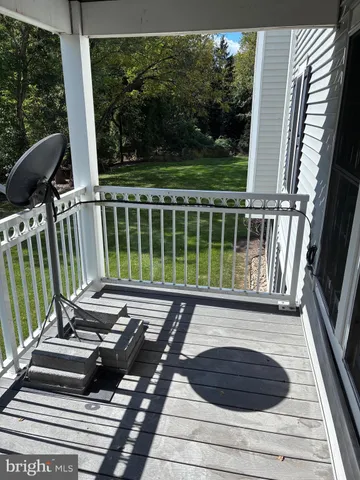 a view of balcony with wooden floor and outdoor seating