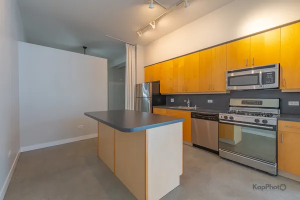 a kitchen with stainless steel appliances a sink stove and a refrigerator