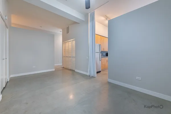 a bedroom with bed and a potted plant