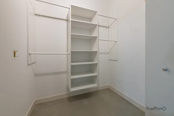 an empty room with closet and windows