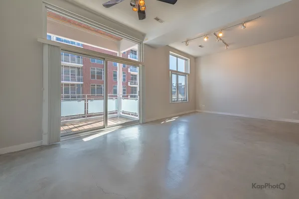 an empty room with windows and closet