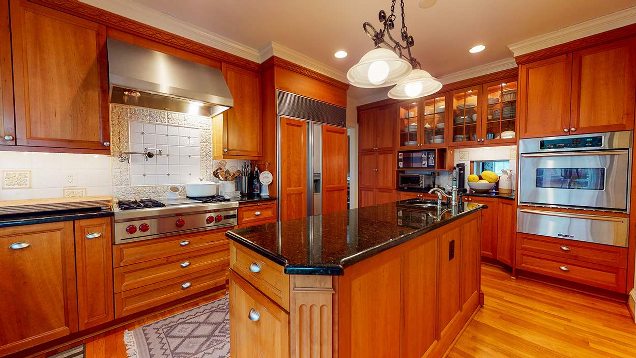 3816 Dover Road Durham, NC 27707 - Photo 12 of 30 a kitchen with stainless steel appliances granite countertop a stove and cabinets