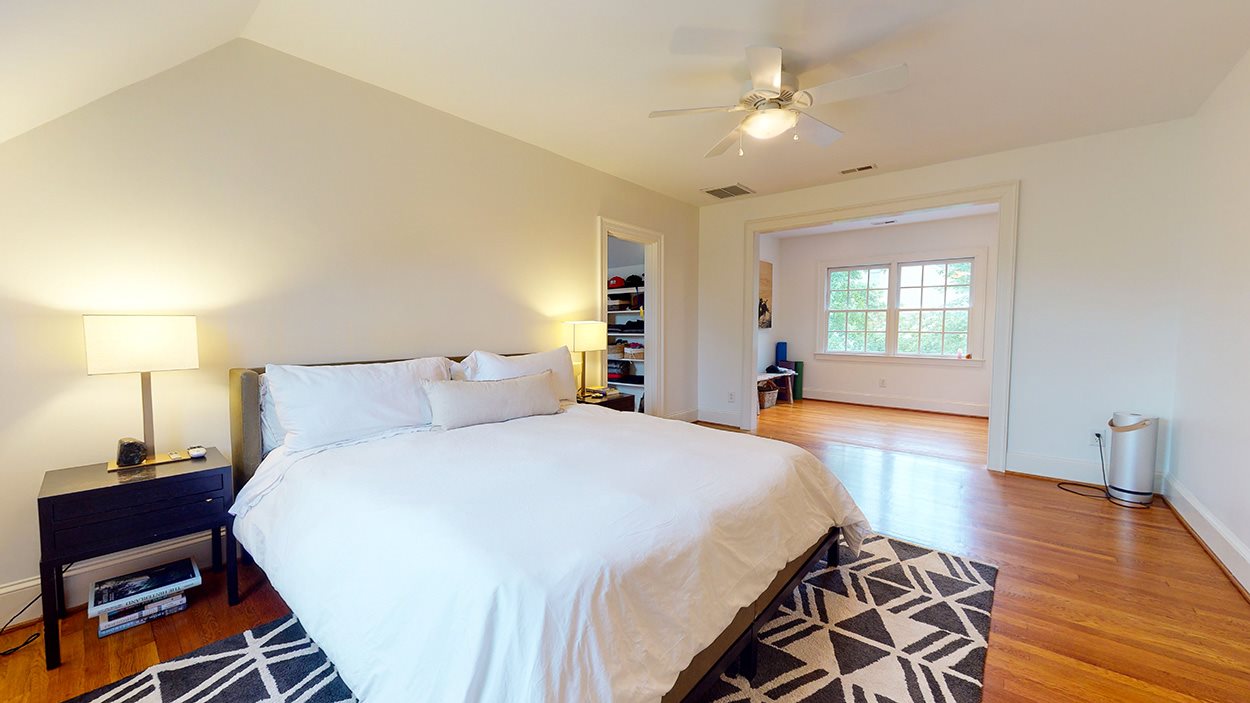 3816 Dover Road Durham, NC 27707 - Photo 19 of 30 a spacious bedroom with a bed and wooden floor