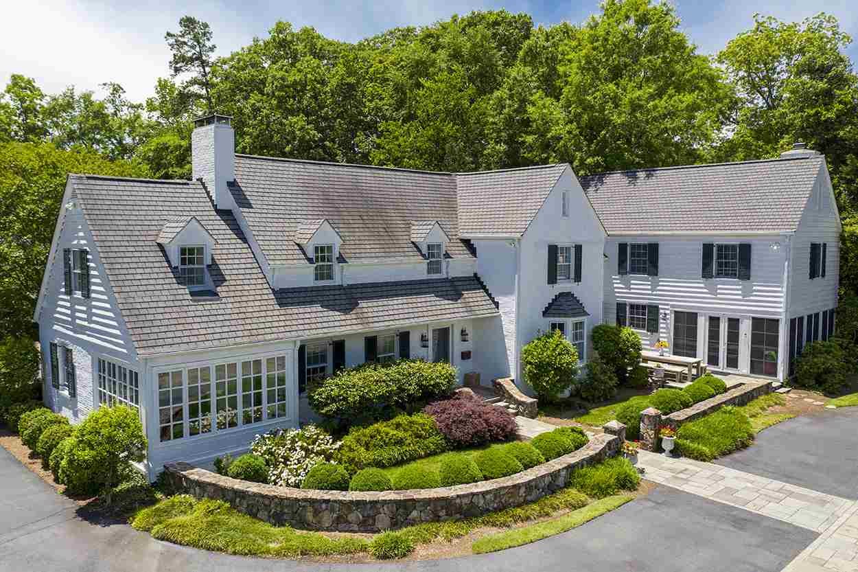 3816 Dover Road Durham, NC 27707 - Photo 2 of 30 a front view of a house with a yard table and chairs
