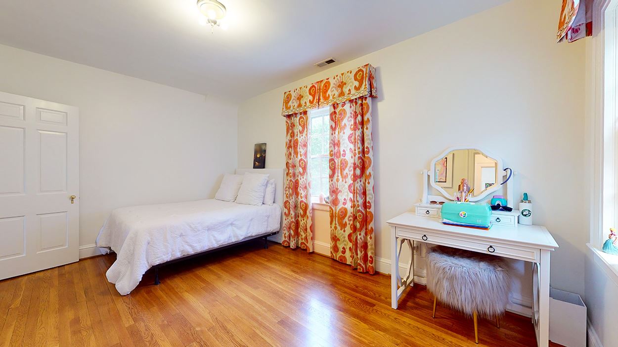 3816 Dover Road Durham, NC 27707 - Photo 21 of 30 a bedroom with a bed and a wooden floor