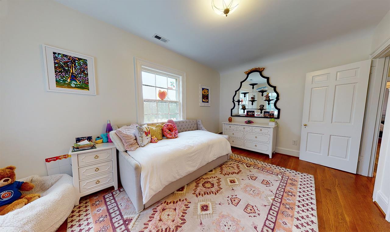 3816 Dover Road Durham, NC 27707 - Photo 23 of 30 a bedroom with a bed and wooden floor