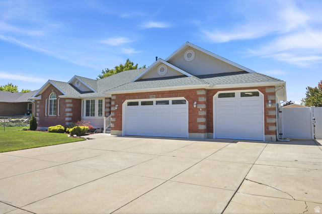 776 Flint Street Layton, UT 84041 - Photo 39 of 41 Brick facade residence featuring a multi-car garage with two white doors