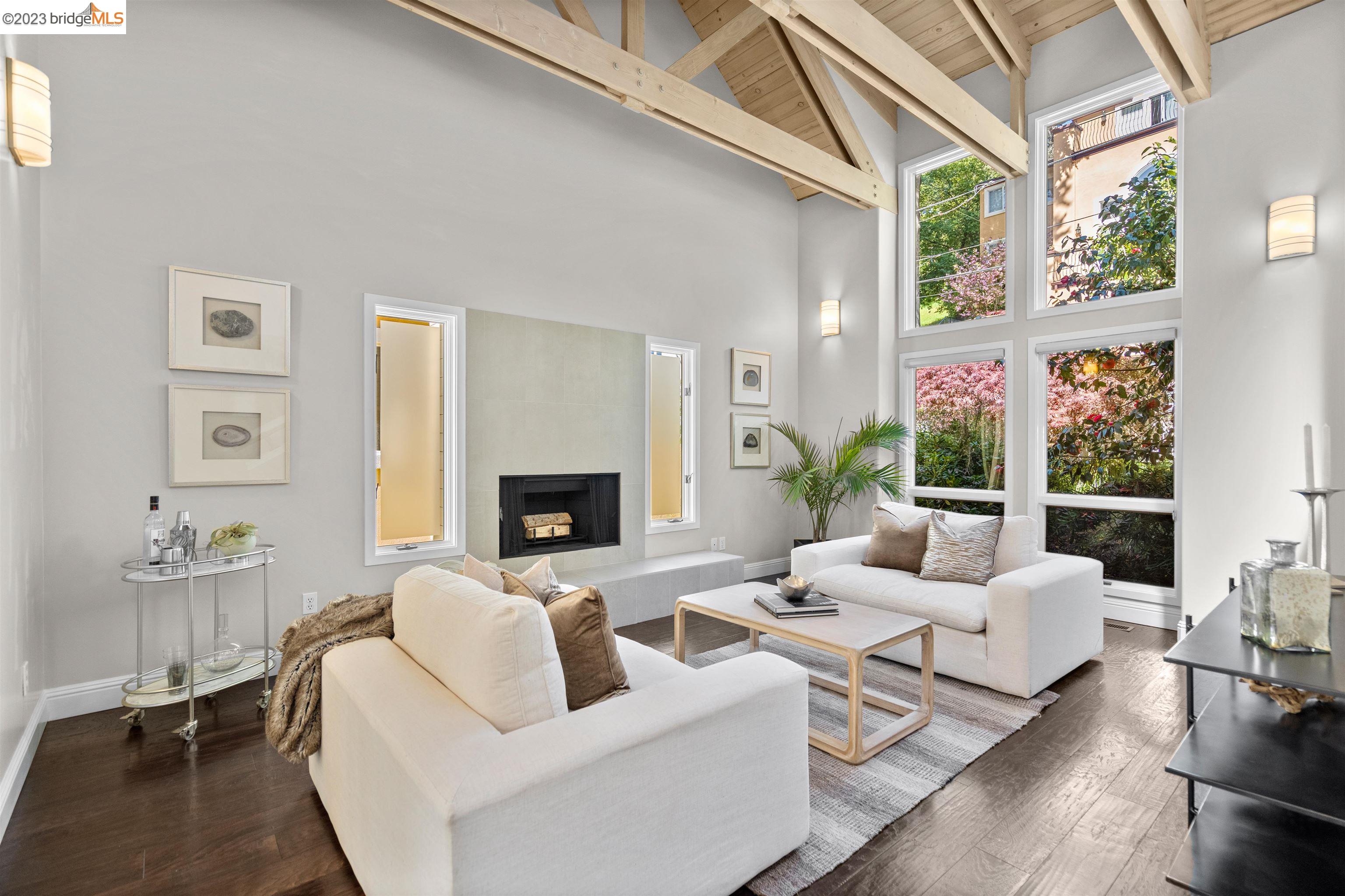 a living room with furniture large window and a fireplace