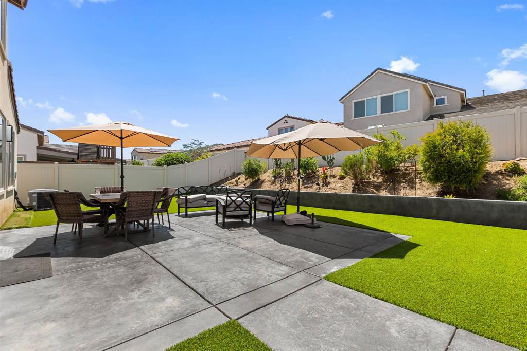 29809 Gypsy Vanner Way Menifee, CA 92584 - Photo 35 of 45 a view of a house with a yard and sitting area