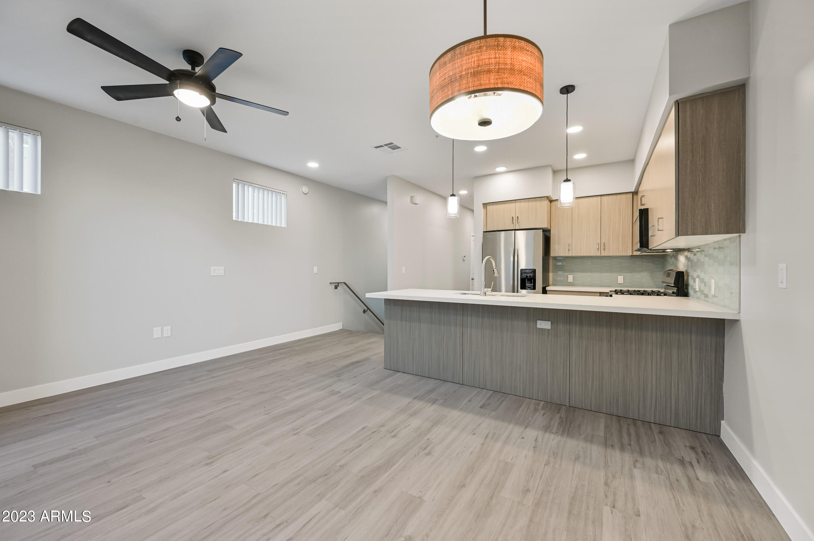 1023 West 5th Street, Unit 1006 Tempe, AZ 85281 - Photo 7 of 35 a kitchen with stainless steel appliances granite countertop a sink and a stove
