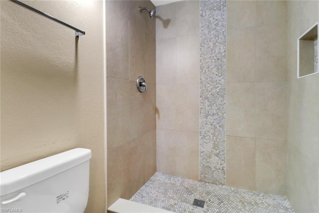 5214 Treetops Drive, Unit I Naples, FL 34113 - Photo 13 of 18 a bathroom with a shower toilet and sink