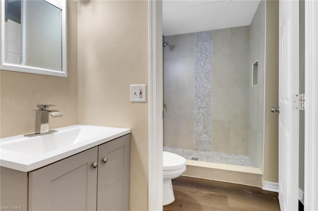 5214 Treetops Drive, Unit I Naples, FL 34113 - Photo 15 of 18 a bathroom with a sink a toilet and a bathtub