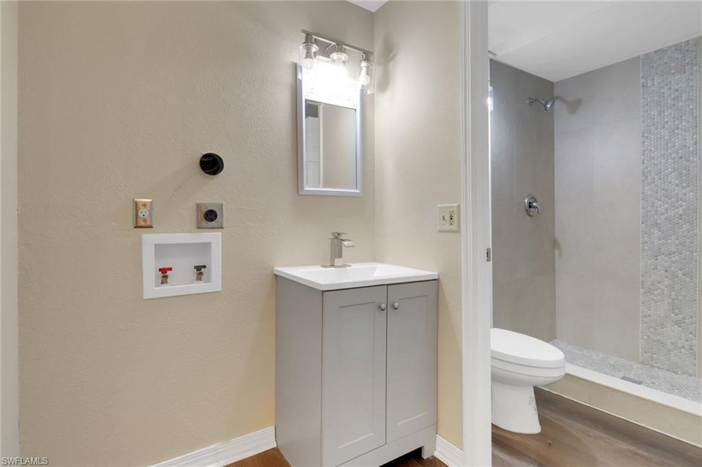 5214 Treetops Drive, Unit I Naples, FL 34113 - Photo 16 of 18 a bathroom with a sink a toilet and shower