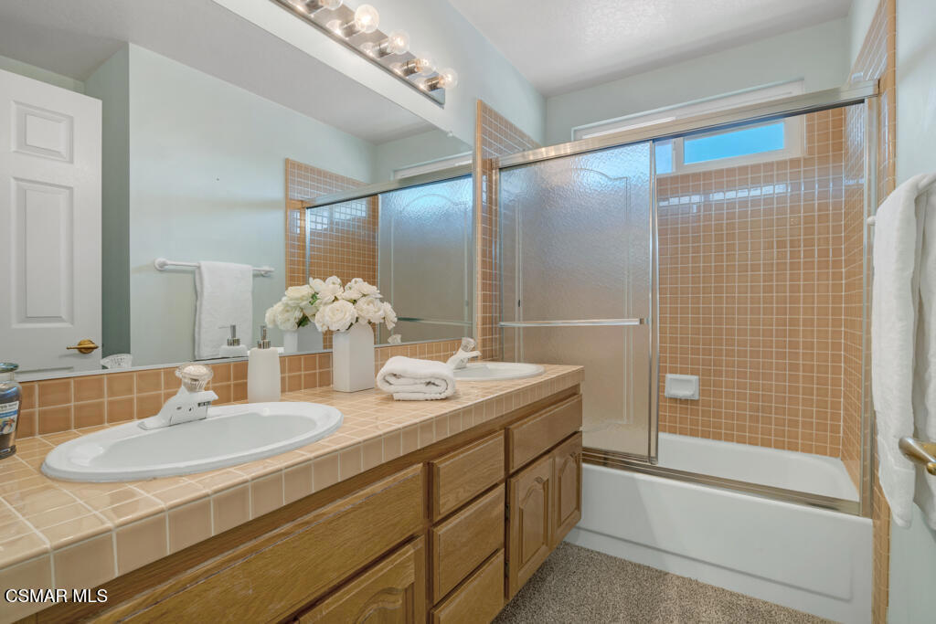 5339 Seneca Place Simi Valley, CA 93063 - Photo 49 of 76 a bathroom with a double vanity sink and a mirror