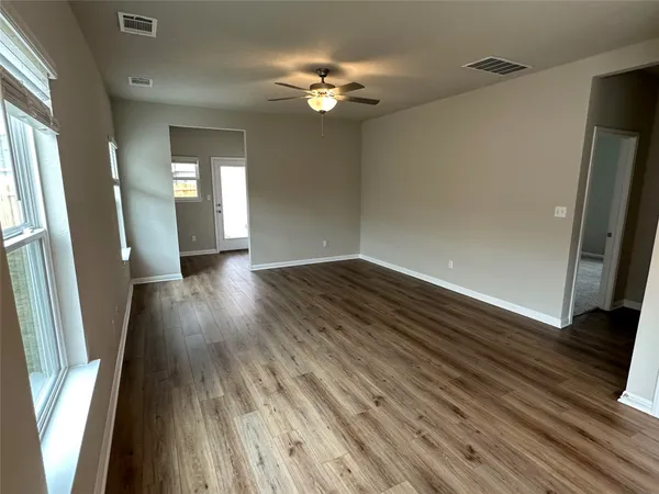 wooden floor in an empty room with a window