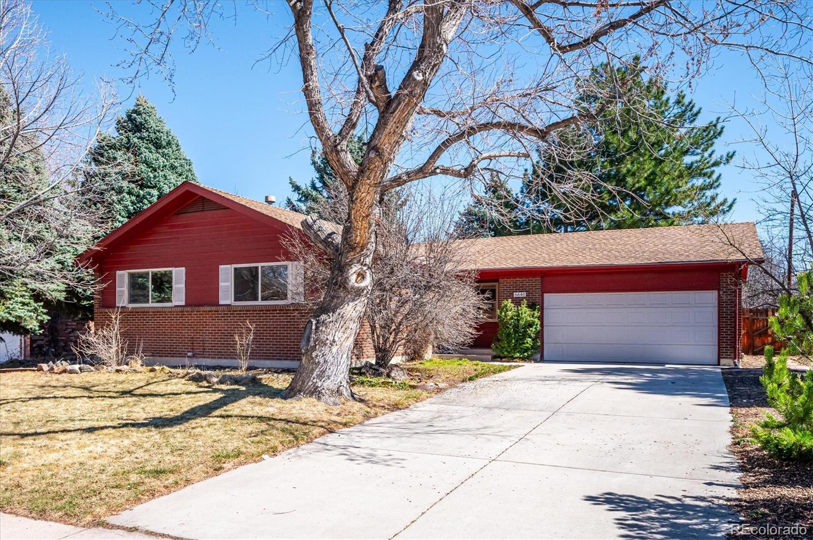 6640 South Williams Circle West Centennial, CO 80121 - Photo 1 of 23 a front view of a house with a yard