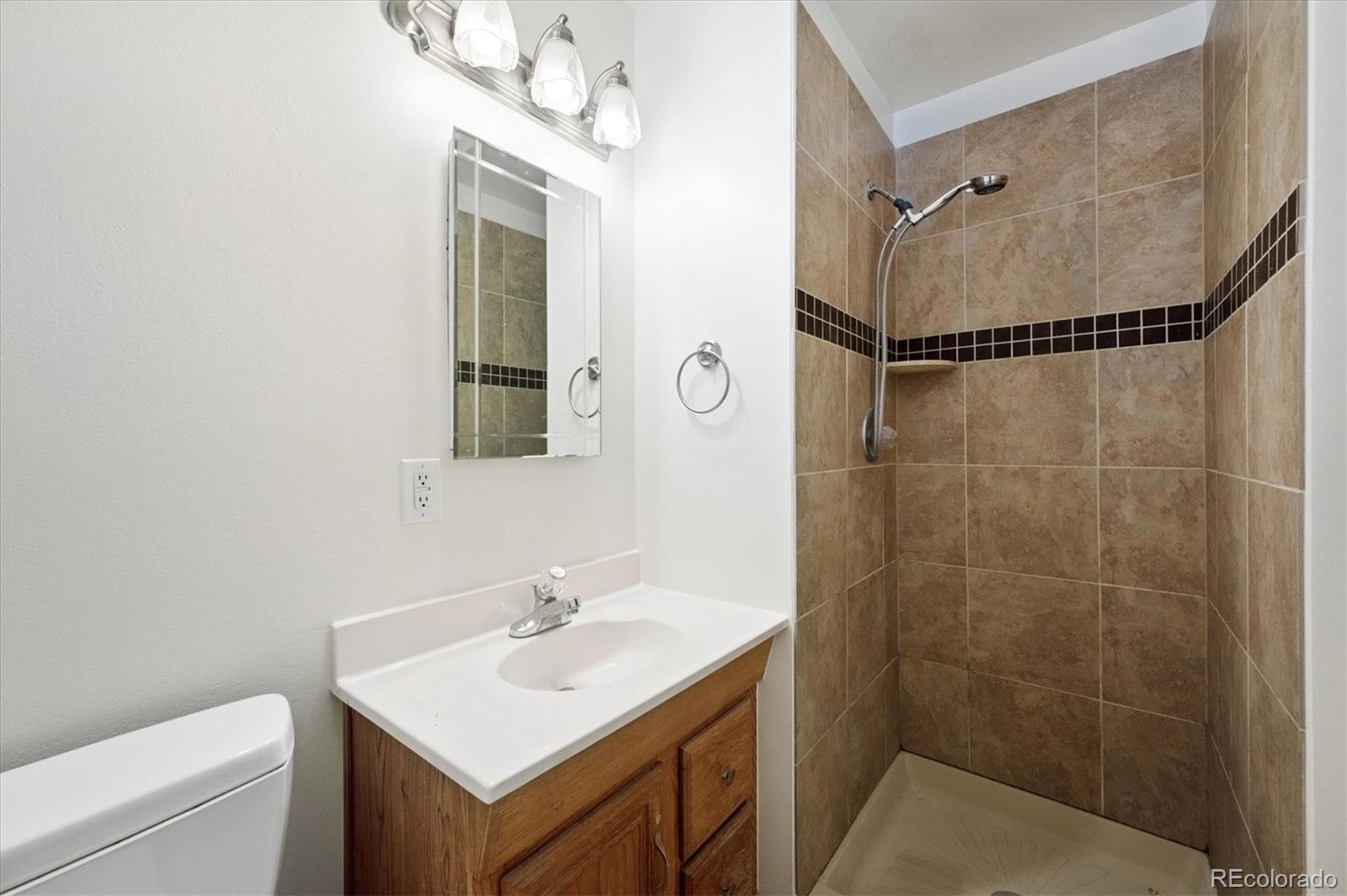 6640 South Williams Circle West Centennial, CO 80121 - Photo 11 of 23 a bathroom with a sink toilet and shower