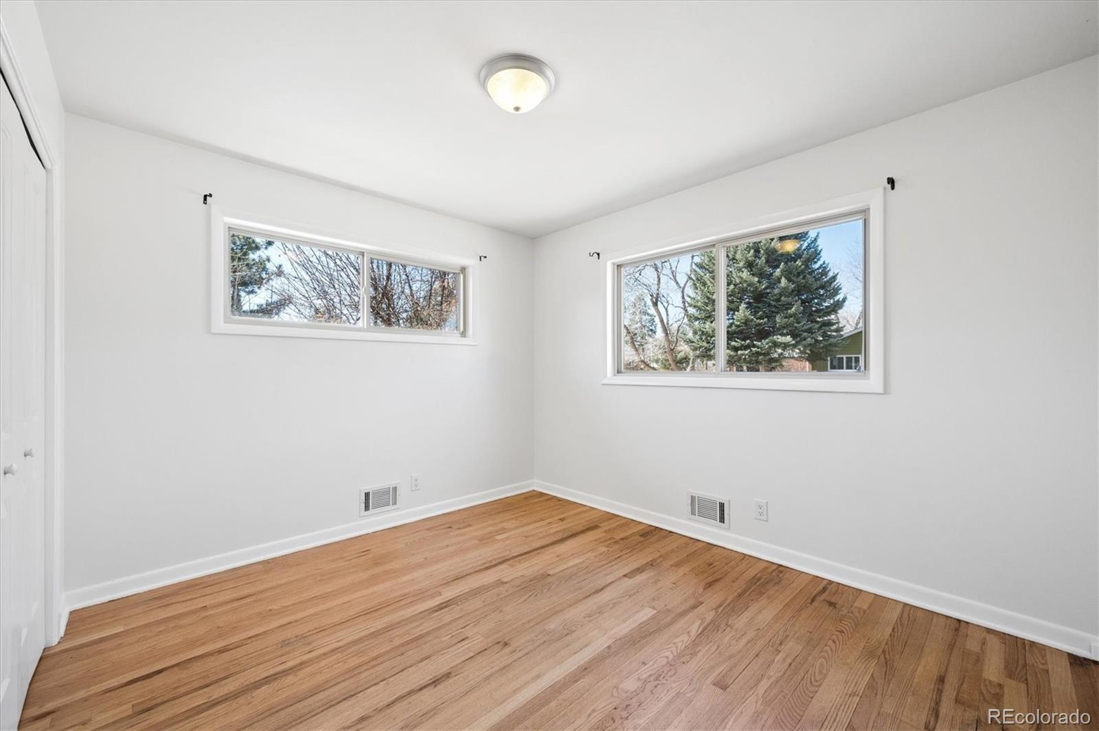6640 South Williams Circle West Centennial, CO 80121 - Photo 12 of 23 a view of an empty room with wooden floor and window