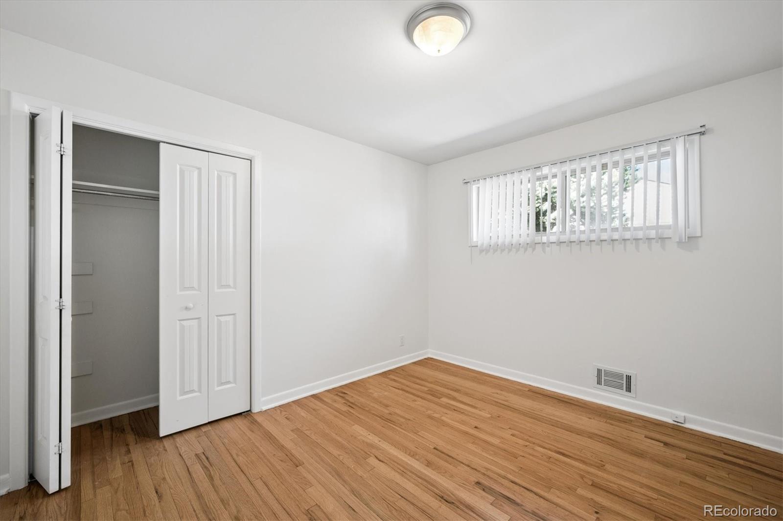 6640 South Williams Circle West Centennial, CO 80121 - Photo 13 of 23 an empty room with wooden floor and windows